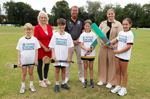 Cricket Ireland chairman Brian MacNeice (centre), with Junior Ministers Pam Cameron (left) and Aisling Reilly (right), and some young participants from the day’s events