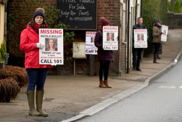 Friends of Nicola Bulley hold missing person appeal posters along the main road in the village in St Michael’s on Wyre