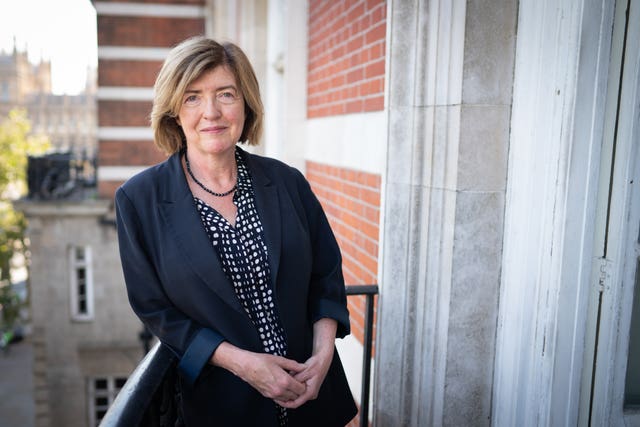 Sue Gray leaning on a balcony railing