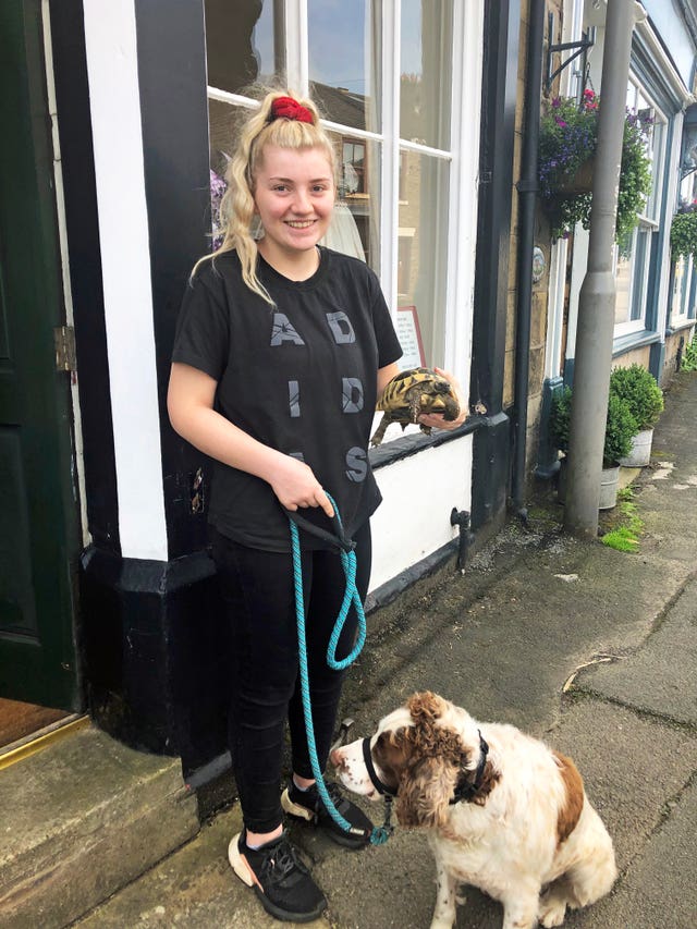 Anna Coleman, 18, with her tortoise Nelly and dog Henry, who were evacuated with her and her family (Eleanor Barlow/PA)