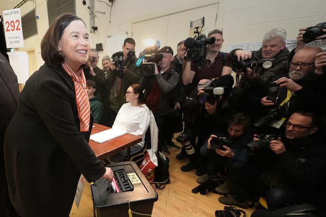 Mary Lou McDonald faces a wall of photographers and reporters as she dropped her vote into the ballot box