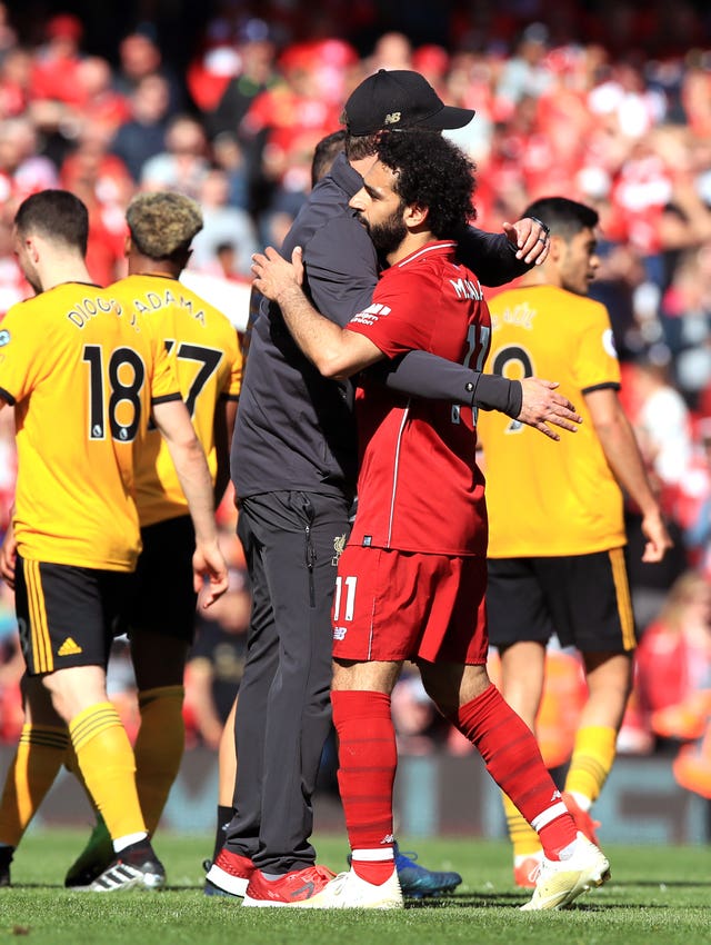 Jurgen Klopp, left, embraces Mohamed Salah after Liverpool's win over Wolves was not enough to clinch the title