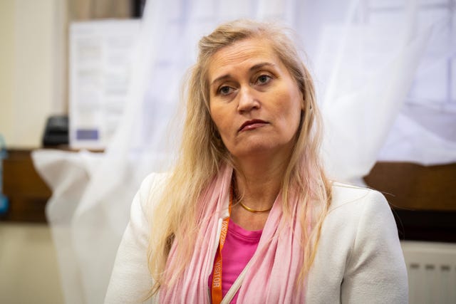 Katalin Kaszas, the victim of the robbery, speaks to shadow minister for justice Kieran Mullan in the House of Commons, London
