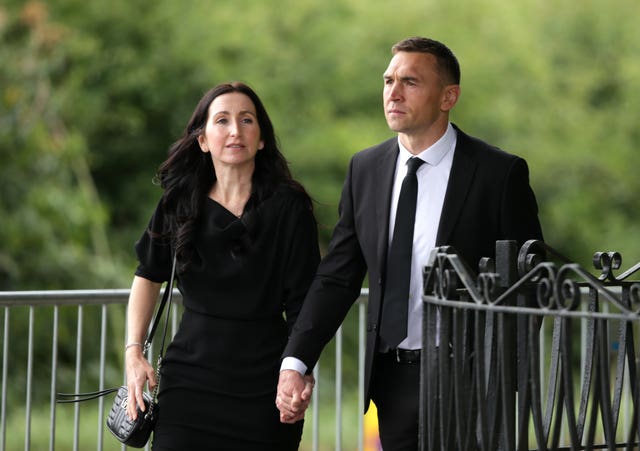 Jayne and Kevin Sinfield holding hands outside crematorium