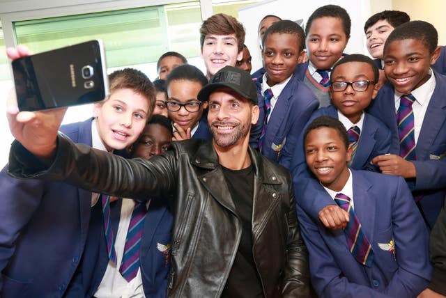 Rio Ferdinand takes a selfie with a group of students from Platanos College, Stockwell