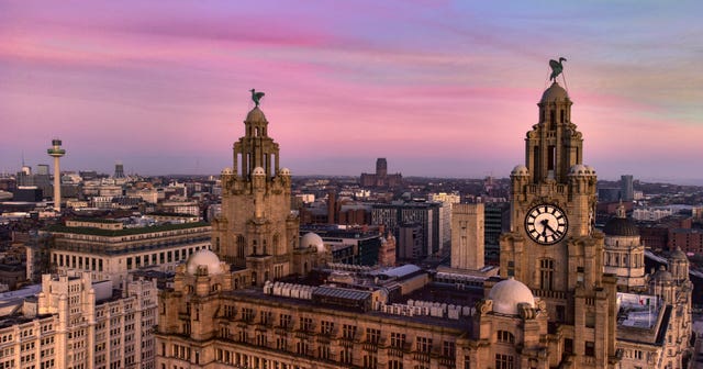 The sun sets behind the Royal Liver Building (Peter Byrne/PA)