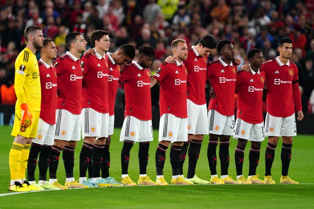 Manchester United players take part in a minute's silence before their Europa League match against Real Sociedad