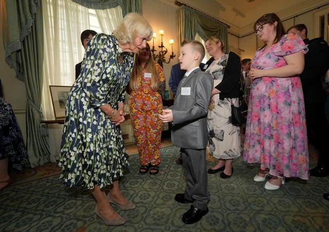 Queen Camilla meets 10-year-old Literacy Champion Jayden Lowndes, from Stoke-on-Trent as she hosts community volunteers and authors at Clarence House, central London, to celebrate the National Literacy Trust charity’s 30th anniversary