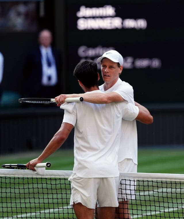 Jannik Sinner and Carlos Alcaraz embrace following the Wimbledon final