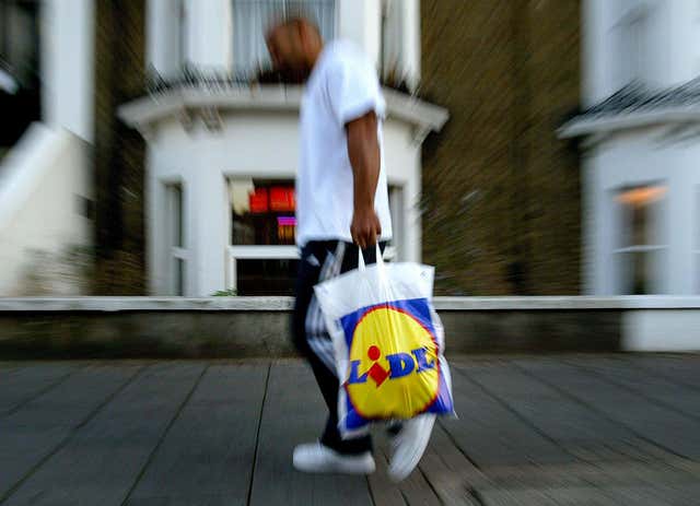 member of the public carrying a Lidl Supermarket shopping bag in London.