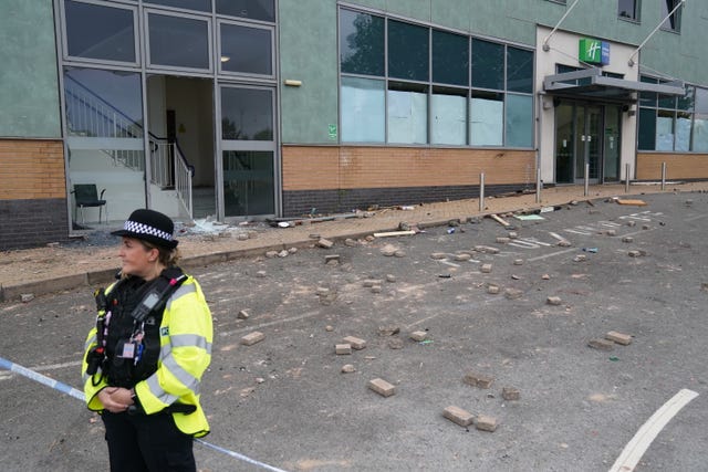 A police officer guarding the Holiday Inn Express in Tamworth