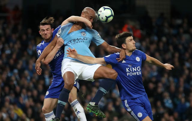 Vincent Kompany battles for the ball with Leicester duo Ben Chilwell and Harry Maguire