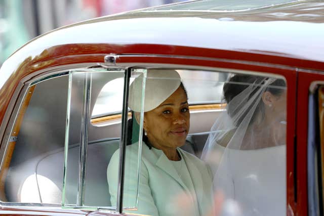 Meghan rides in a car accompanied by her mother, Doria Ragland (Aaron Chown/PA)