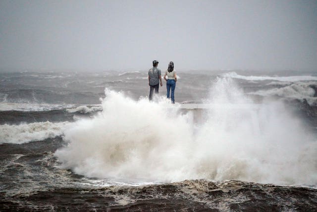The Couple sculpture by Sean Henry at Newbiggin-by-the-Sea on the Northumberland coast was battered by waves on Friday morning