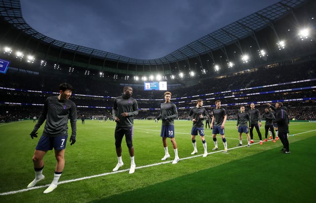 Spurs' players warm up at the new stadium 