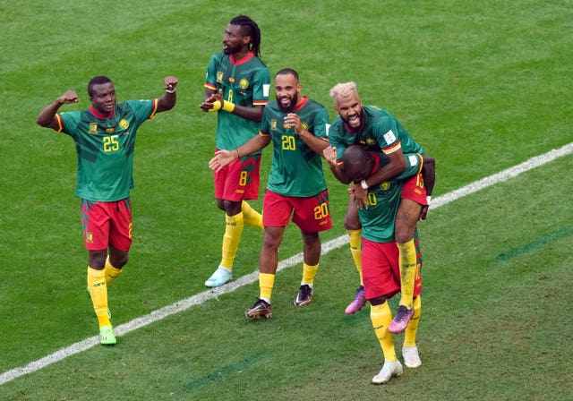 Cameroon’s Eric Maxim Choupo-Moting, right, celebrates scoring his side's equaliser against Serbia 