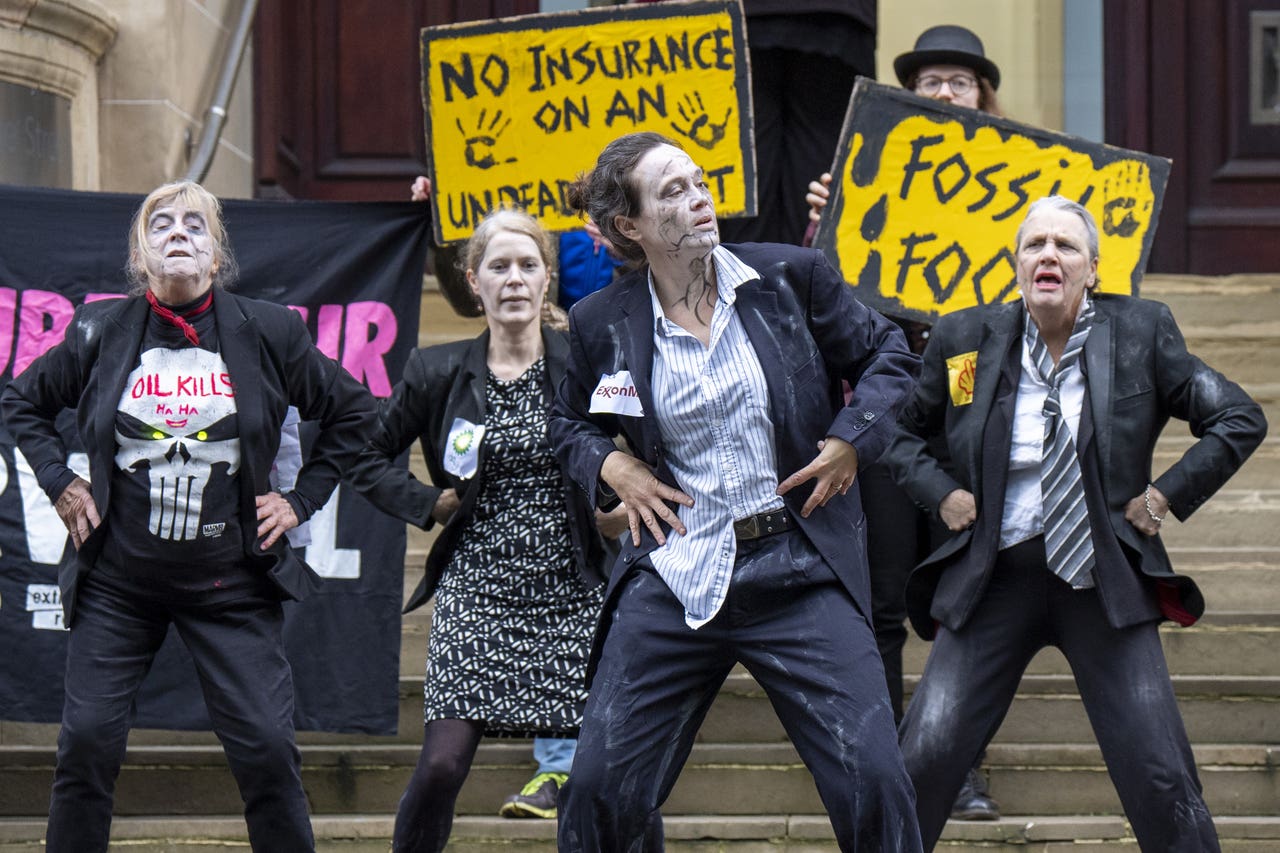 Climate activists in ‘zombie dance’ protest outside insurance offices