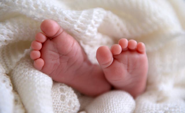 A new born baby’s feet  (Andrew Matthews/PA)
