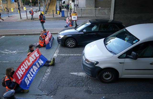 Protesters from Insulate Britain blocking a road near Canary Wharf in east London