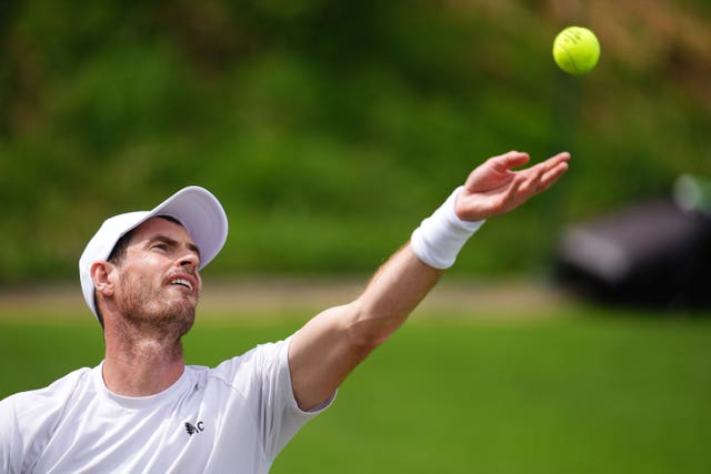 Andy Murray throws the ball up to serve during a practice set at Wimbledon