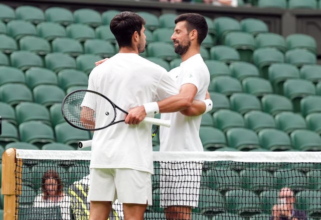 Novak Djokovic, right, and Carlos Alcaraz embrace after their practice session