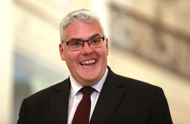 DUP leader Gavin Robinson in balck suit, smiling