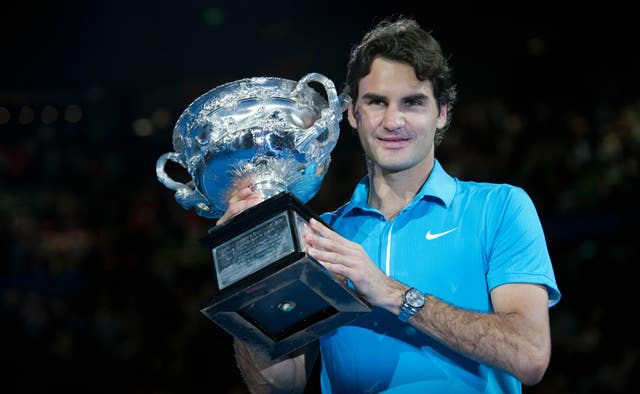 Roger Federer holds the Norman Brookes Challenge Cup after beating Andy Murray in 2010