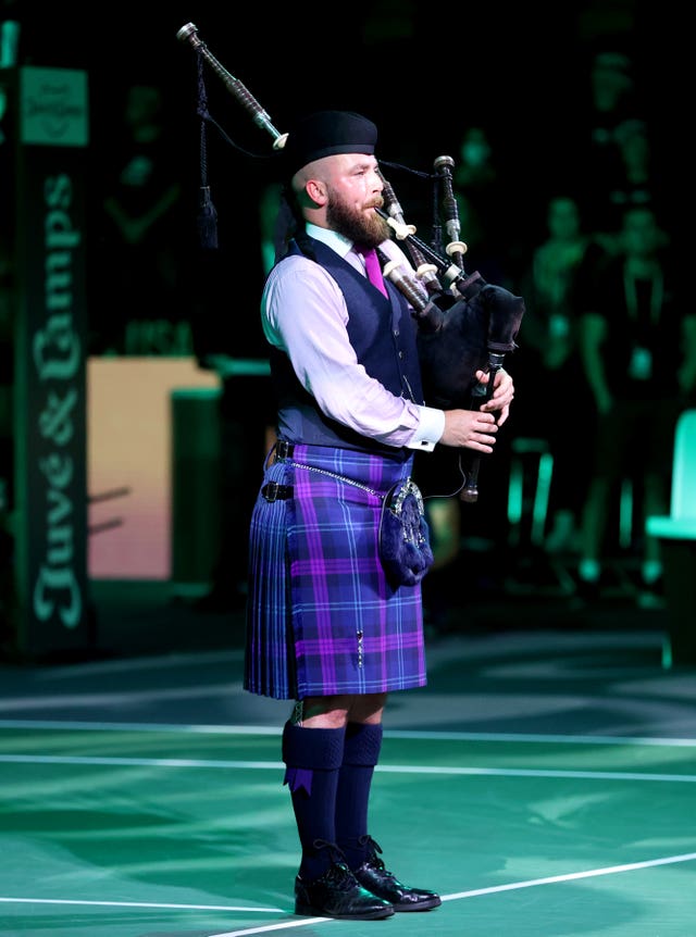 A lone piper played a tribute to the Queen before the tie
