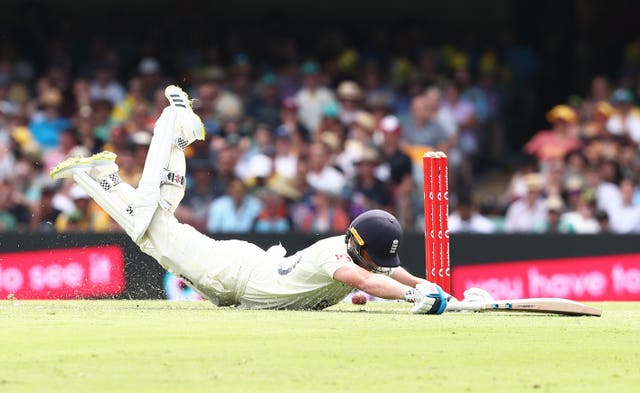 England’s Ollie Pope dives in to make a run at The Gabba