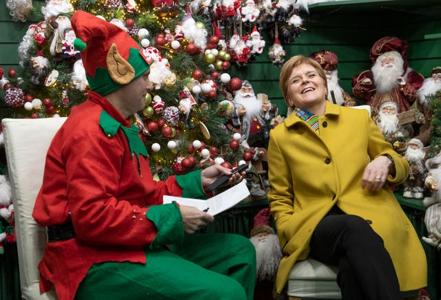 Nicola Sturgeon is interviewed by a journalist dressed as a Christmas elf in Crieff