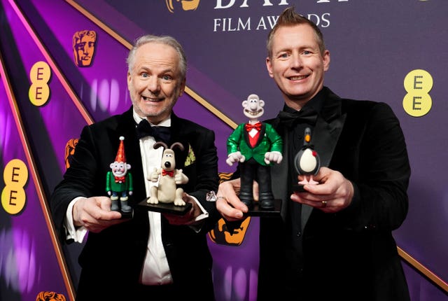 Nick Park, left, and Merlin Crossingham, holding figures from Wallace And Gromit, attending the 78th British Academy Film Awards at the Royal Festival Hall, Southbank Centre, London