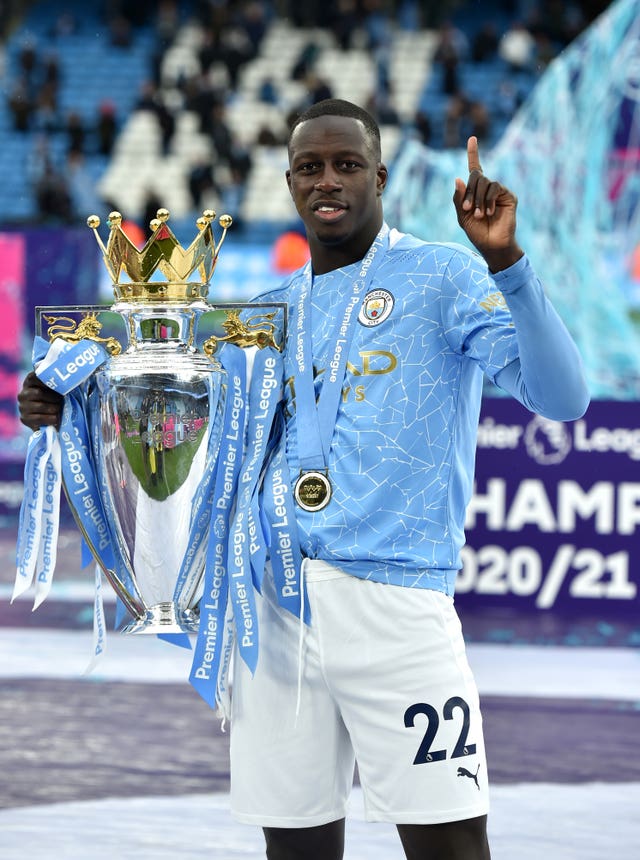 Manchester City’s Benjamin Mendy celebrates with the trophy after the final whistle in the Premier League