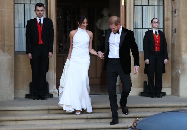 The newly weds changed clothes before the evening's festivities (Steve Parsons/PA)