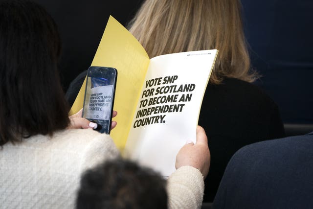 A delegate takes a picture of the first page of the manifesto book during the party’s General Election manifesto launch at Patina in Edinburgh 