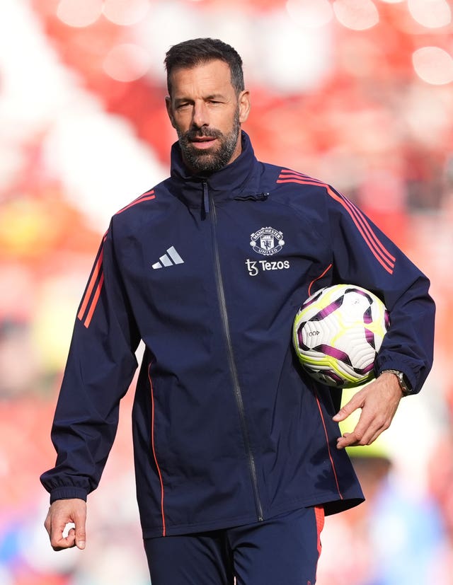 Manchester United interim manager Ruud van Nistelrooy holds a ball