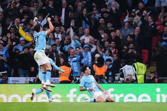 Manchester City’s Nico O’Reilly slides on his knees to celebrate scoring his first goal in the Carabao Cup final