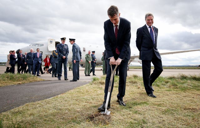 Mr Williamson performs the cutting of the sod during a visit to RAF Lossiemouth (Jane Barlow/PA)