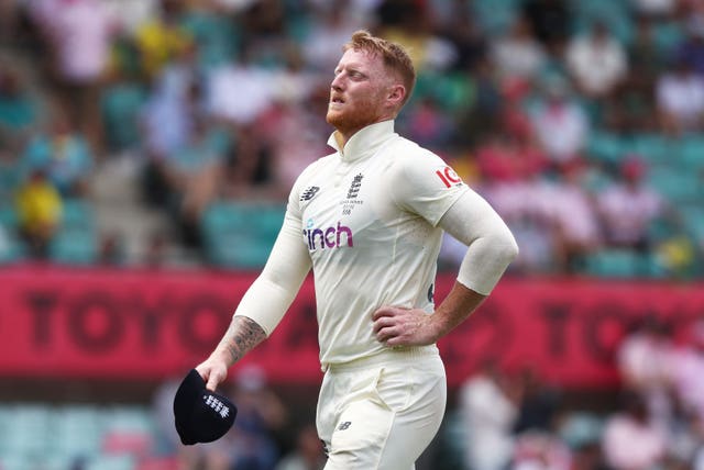 Ben Stokes clutches his left side as he leaves the field.