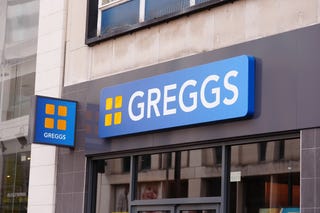 View of the Greggs sign above a shop