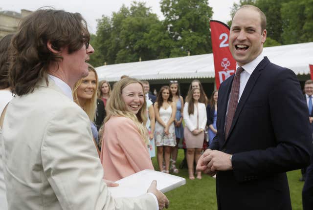 William laughs as he meets comedian Ed Byrne (Kirsty Wigglesworth/PA)