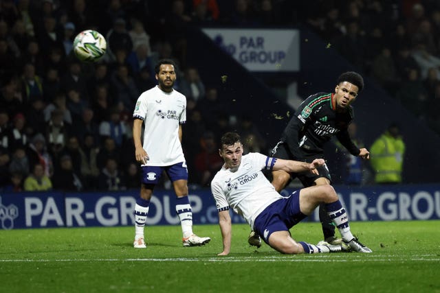 Ethan Nwaneri watches his shot go towards goal as a Preston defender unsuccessfully slides in to tackle