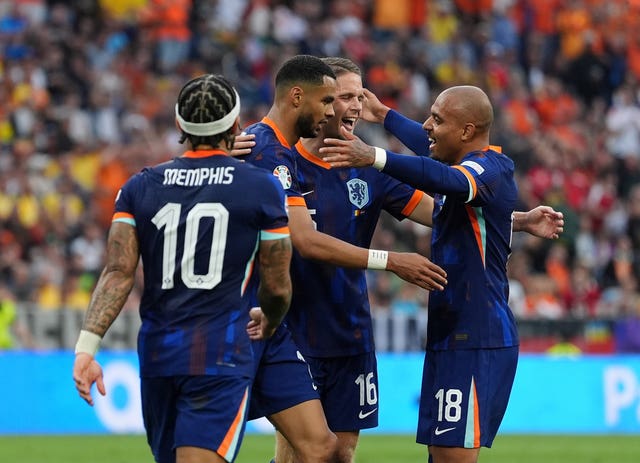 Netherlands’s Donyell Malen (right) celebrates scoring against Romania with his team-mates
