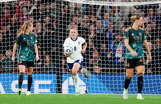 Georgia Stanway, centre, runs back to the centre circle with the ball after scoring England’s first goal