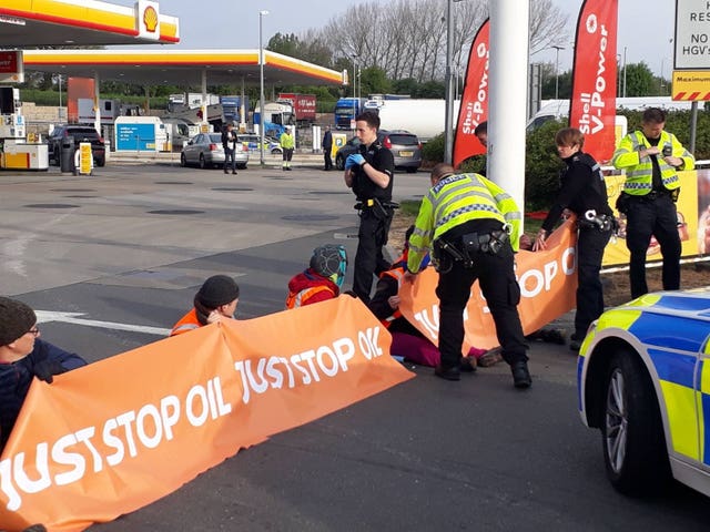 Campaigners staging a protest in the Shell petrol garage at Cobham Services on the M25 in Surrey