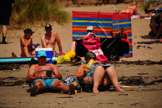 People relaxing on the beach at St Michael’s Bay in Cornwall