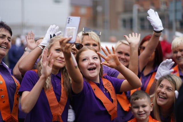 Youngsters take selfies at Carlisle Circus in Belfast ahead of an Orange Order parade 