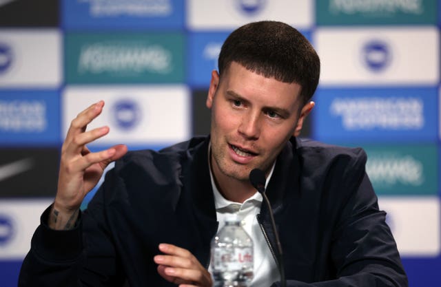 Fabian Hurzeler gestures with his right hand as he talks at a press conference