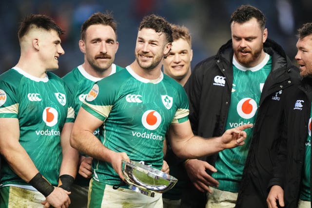 Ireland captain Caelan Doris holds the Centenary Quaich while surrounded by team-mates