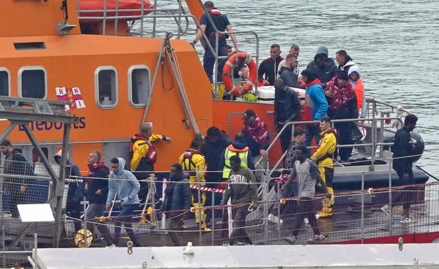 A group of people thought to be migrants are brought in to Dover