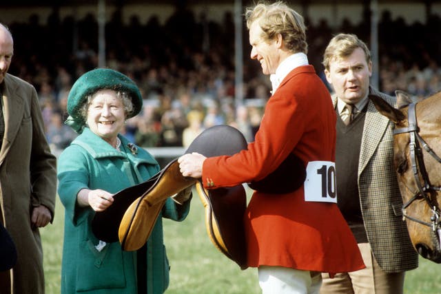 Richard Meade holding a saddle alongside the Queen Mother